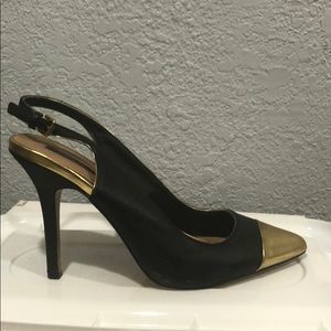 Black pointy pumps with gold caps